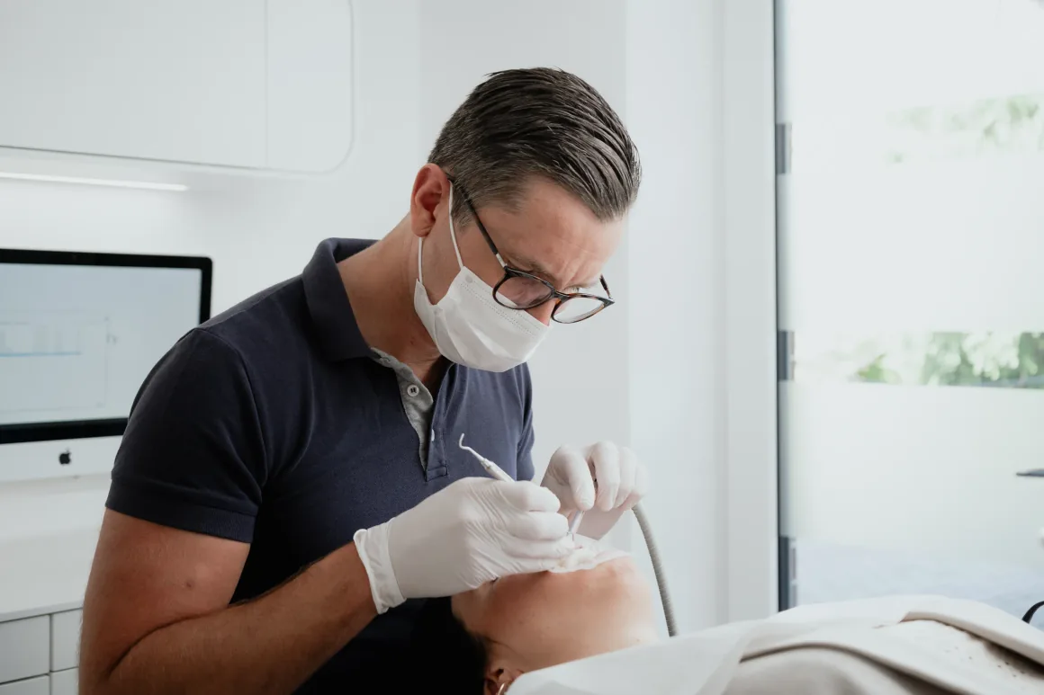 Dentist treating a patient as part of a periodontitis treatment